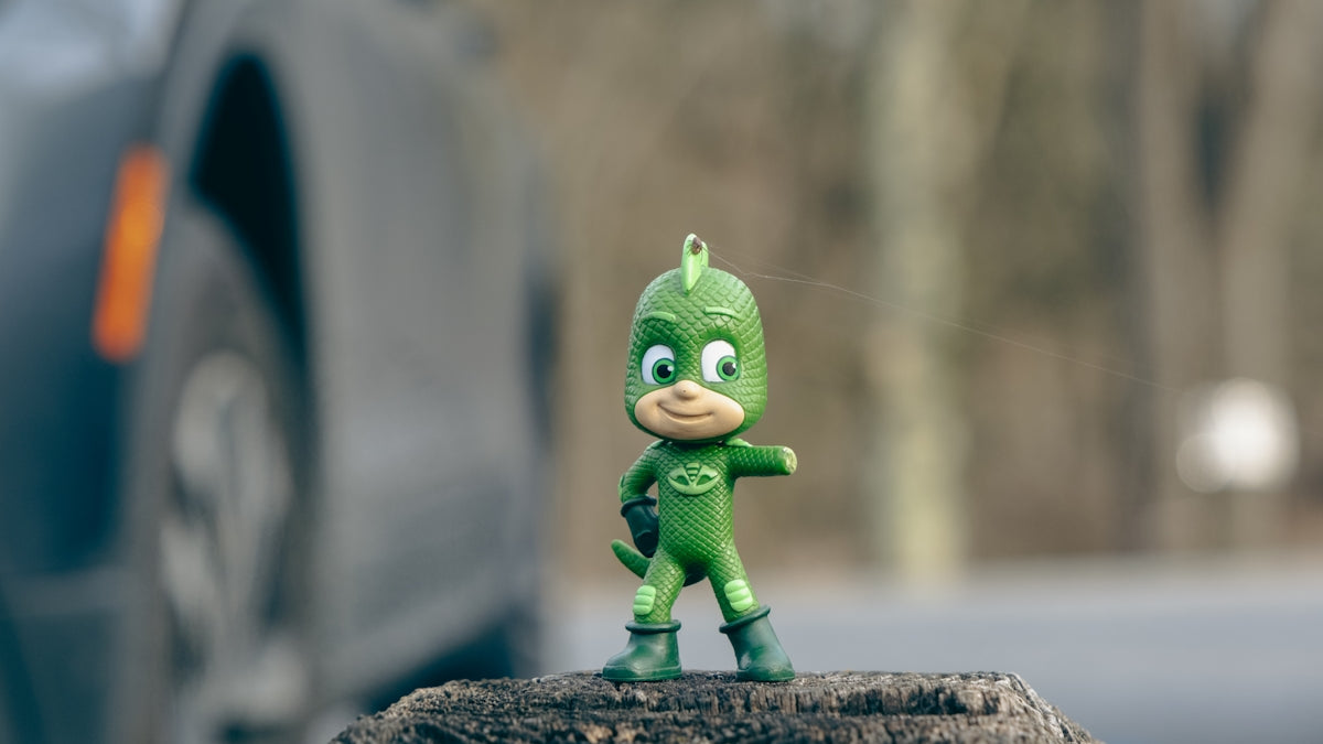 a toy figure is standing on a piece of wood
