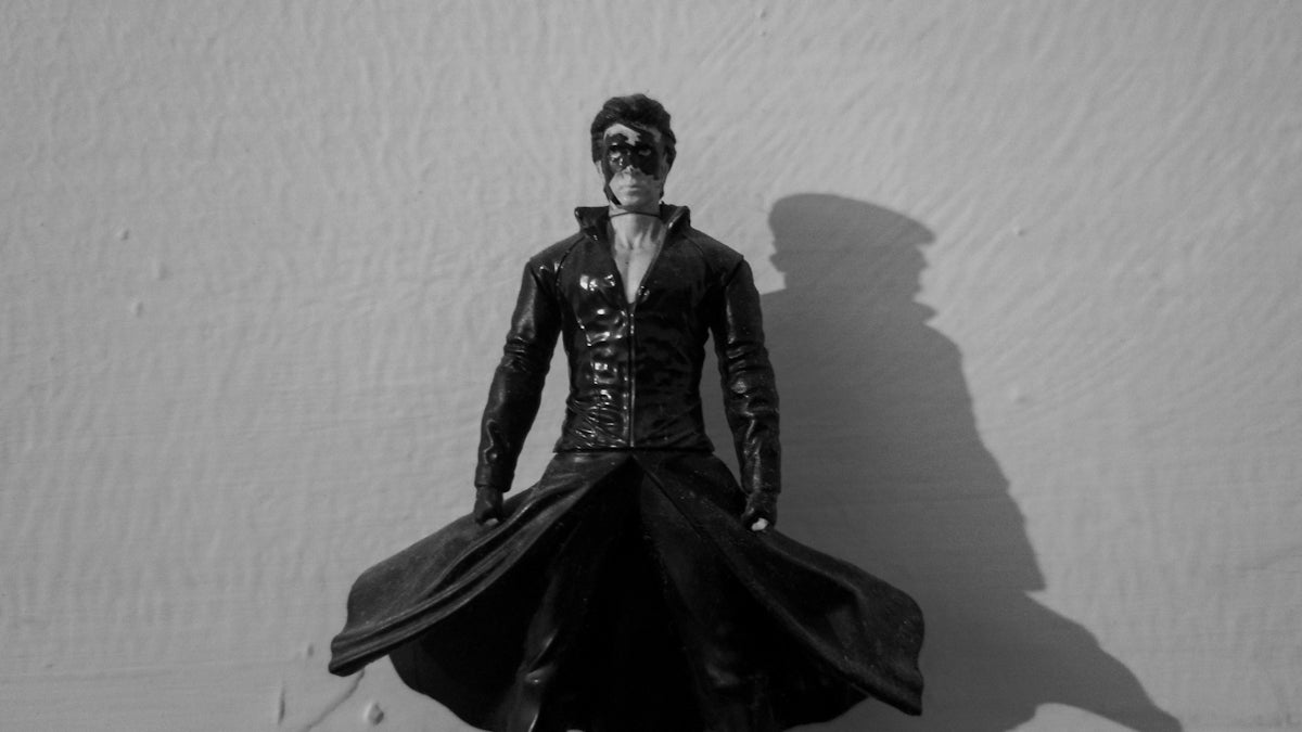 a black and white photo of a man in a leather outfit