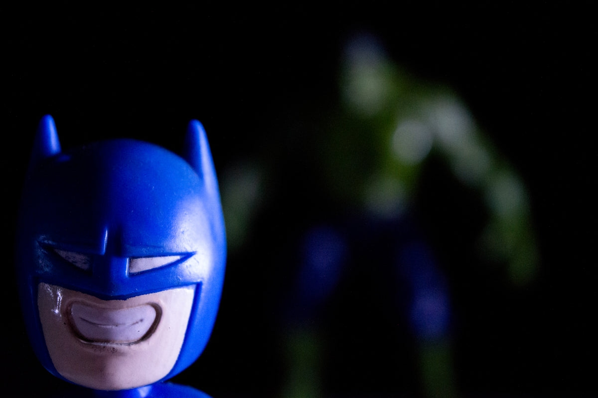 Batman toy in foreground, hulk figure in background