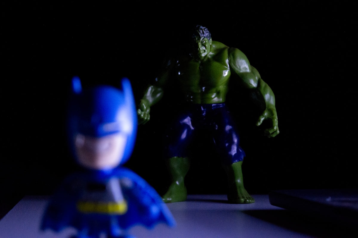 Batman toy in foreground with hulk toy behind