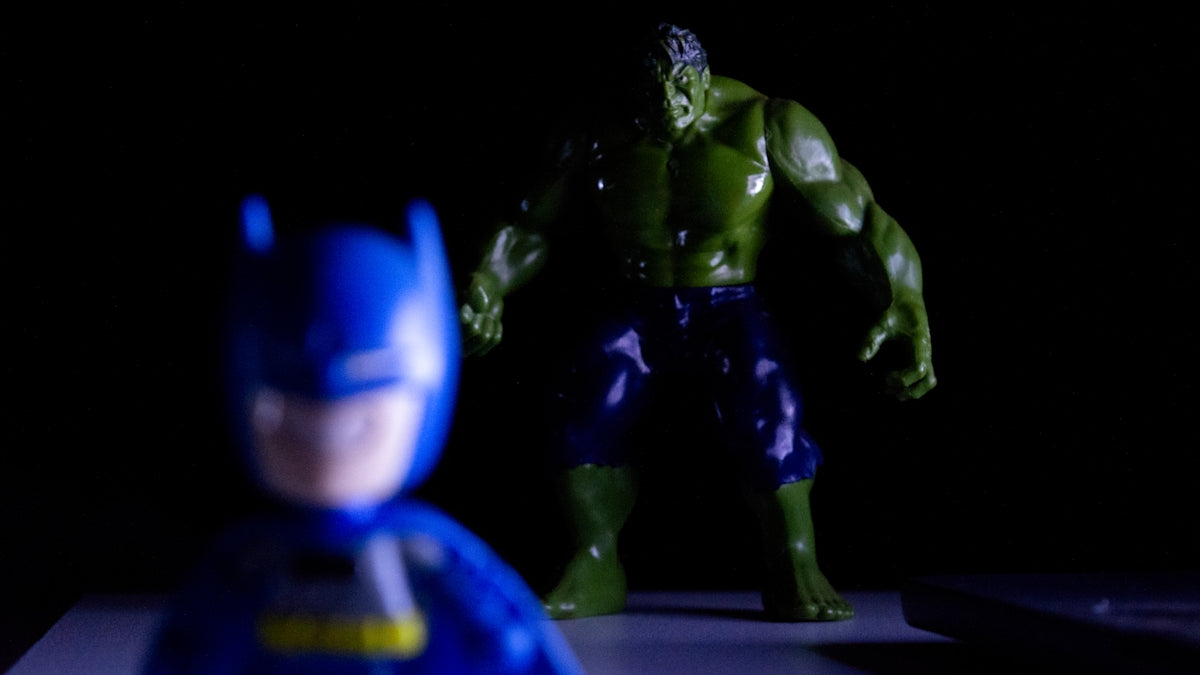 Batman toy in foreground with hulk toy behind