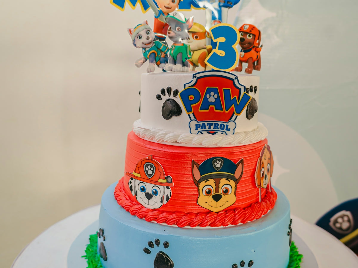 Paw patrol themed birthday cake with three tiers.