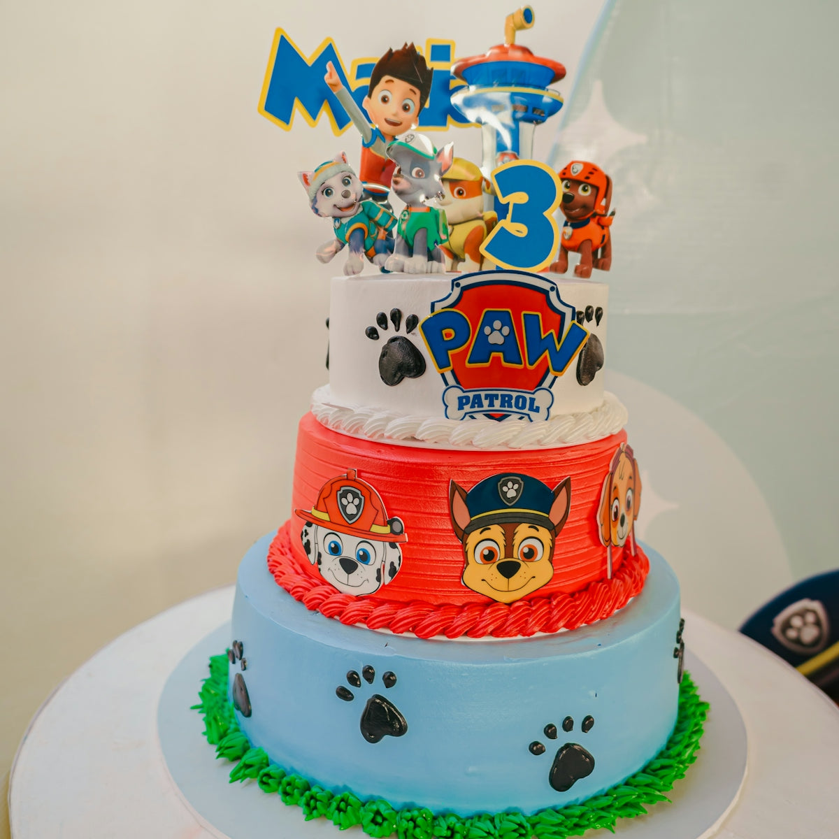 Paw patrol themed birthday cake with three tiers.